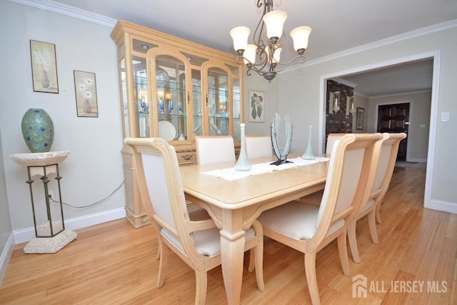 107 N Edward St, Sayreville, NJ 08872 - dining room with a chandelier, light wood finished floors, and crown molding