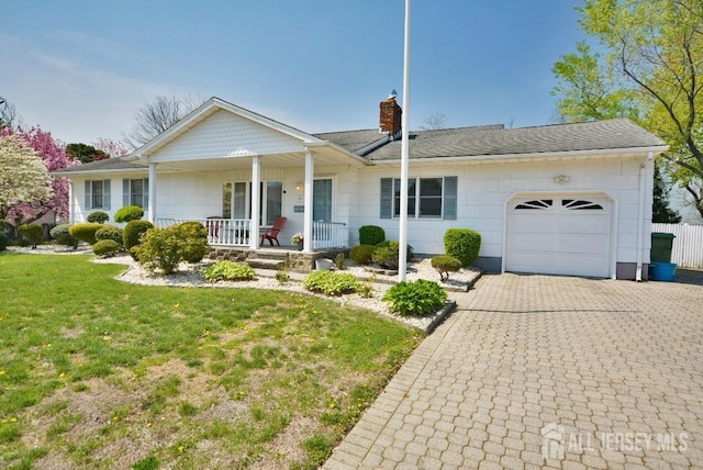 107 N Edward St, Sayreville, NJ 08872 - view of front facade with covered porch, a garage, a chimney, a front lawn, and decorative driveway