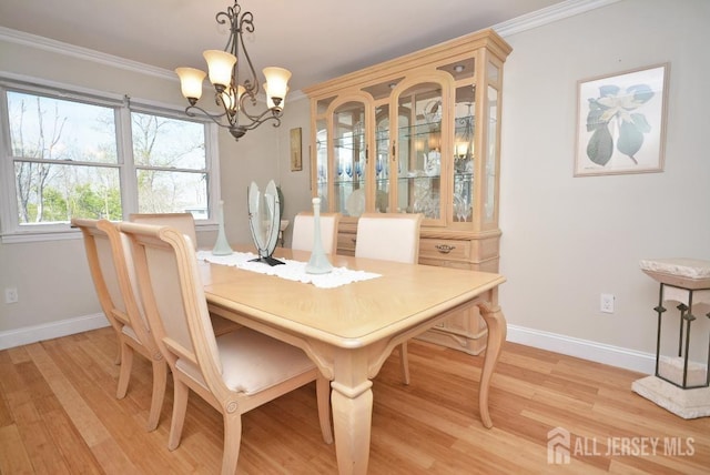 107 N Edward St, Sayreville, NJ 08872 - dining area with a chandelier, light wood-style flooring, and crown molding