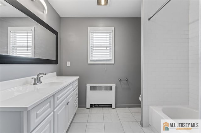 bathroom featuring radiator heating unit, vanity, toilet, shower / bath combination, and marble look tile flooring