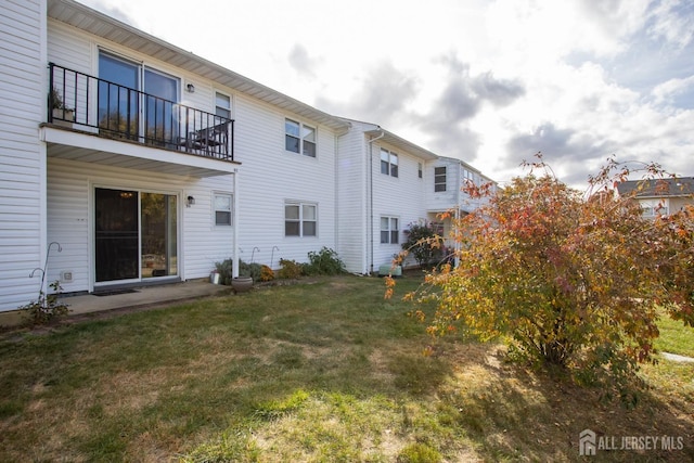 exterior space with a yard and a balcony