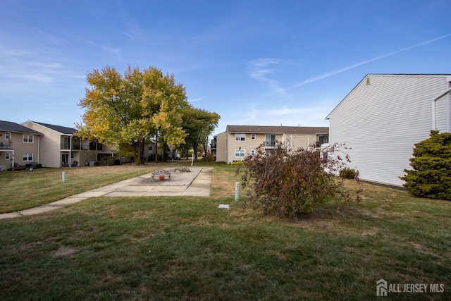 view of yard with a residential view and a patio area