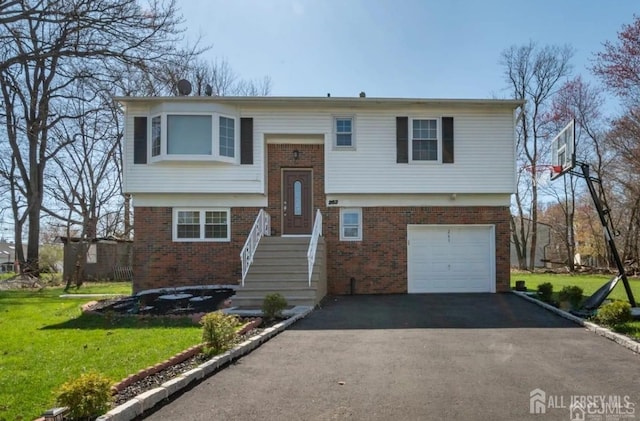 split foyer home with a garage and a front lawn