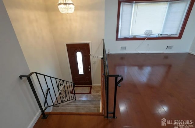 foyer featuring plenty of natural light and dark hardwood / wood-style flooring