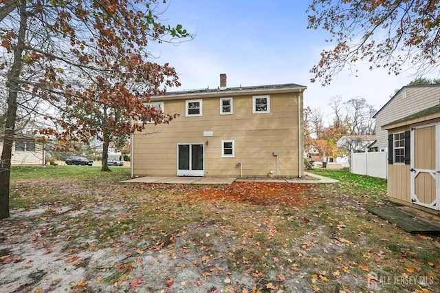 back of property featuring a patio, a chimney, and fence