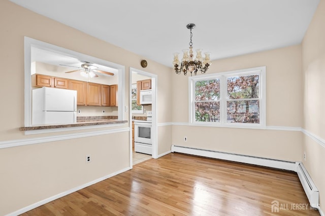 kitchen featuring a baseboard heating unit, white appliances, light wood-style floors, light countertops, and pendant lighting