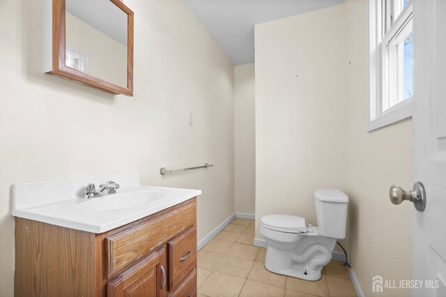 bathroom featuring vanity, tile patterned flooring, and toilet