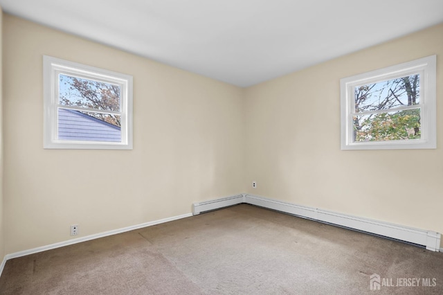 carpeted empty room featuring a baseboard heating unit, a baseboard radiator, and baseboards