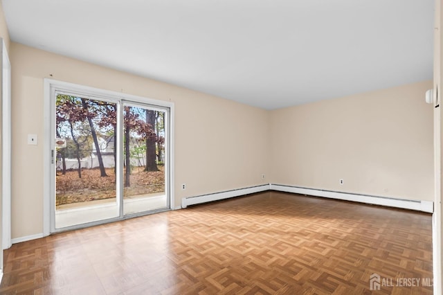 empty room featuring a baseboard heating unit and baseboards