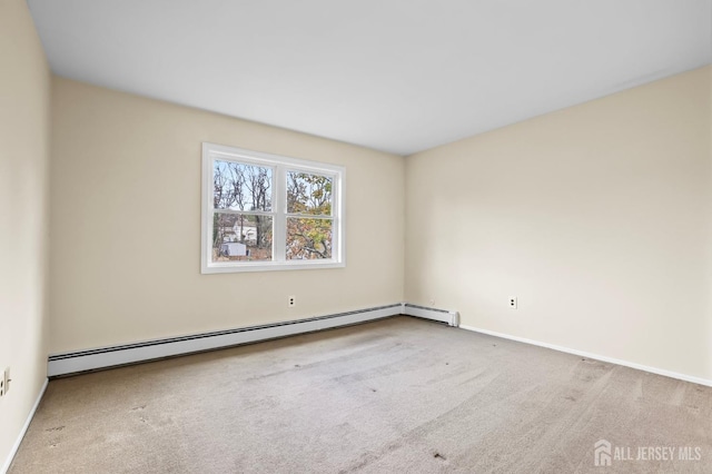 empty room featuring a baseboard radiator and carpet flooring