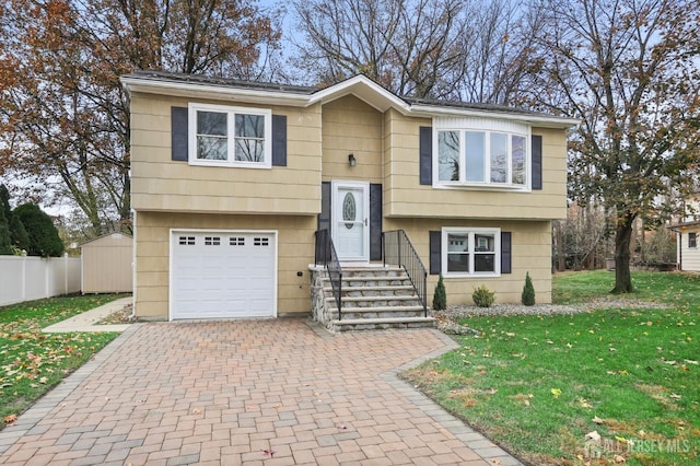 bi-level home with a garage and a front lawn