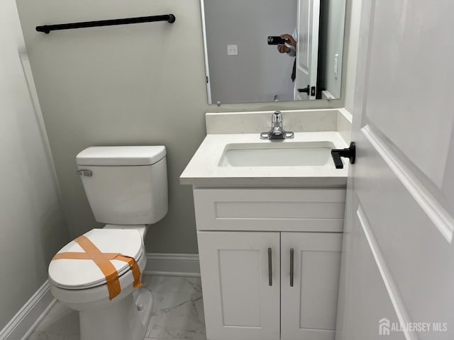 21 Catherine St, Carteret, NJ 07008 - half bath featuring toilet, marble finish floor, vanity, and baseboards