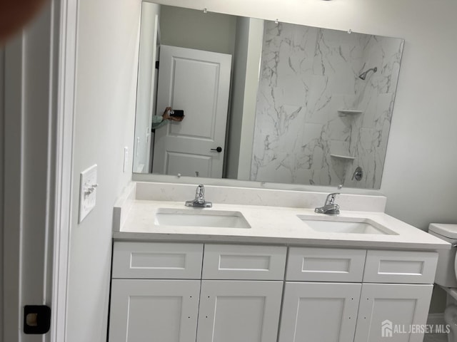 21 Catherine St, Carteret, NJ 07008 - bathroom featuring double vanity, toilet, and a sink