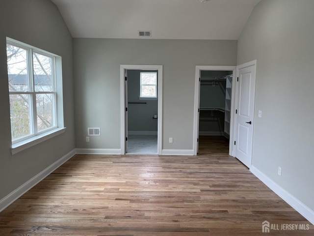 21 Catherine St, Carteret, NJ 07008 - unfurnished bedroom with visible vents, wood finished floors, and vaulted ceiling