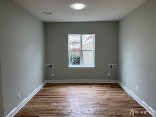 21 Catherine St, Carteret, NJ 07008 - unfurnished room featuring visible vents and wood finished floors