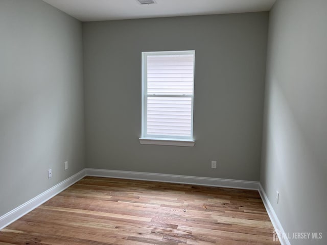 21 Catherine St, Carteret, NJ 07008 - unfurnished room with baseboards, visible vents, and light wood finished floors