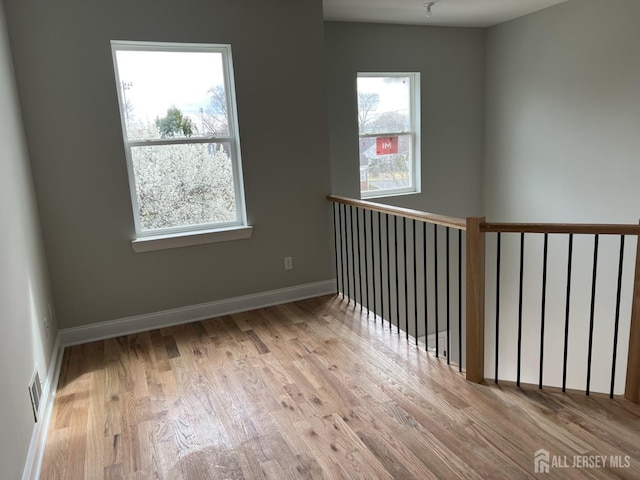 21 Catherine St, Carteret, NJ 07008 - empty room featuring a wealth of natural light, wood finished floors, and baseboards