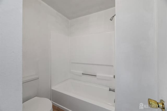 bathroom with toilet and bathtub / shower combination