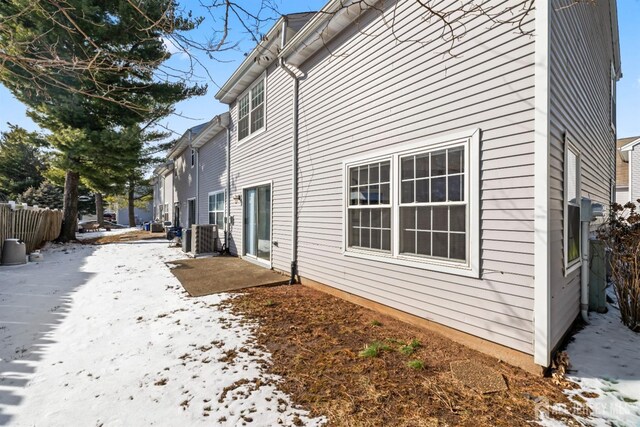 view of snowy exterior featuring central AC