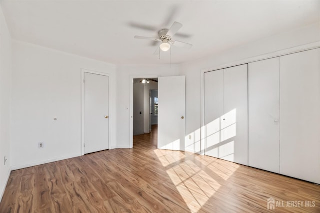 unfurnished bedroom with light hardwood / wood-style floors and ceiling fan