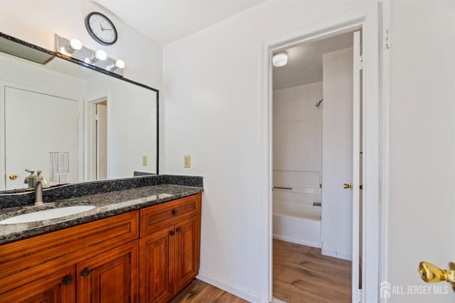 bathroom with shower / bathtub combination, vanity, and wood-type flooring