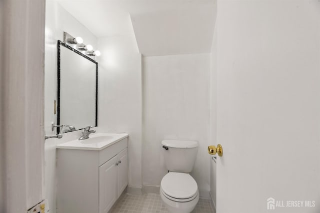 bathroom featuring tile patterned floors, toilet, and vanity