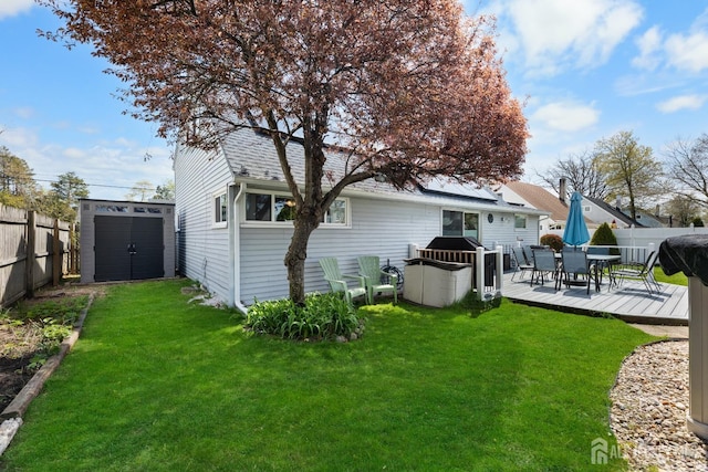 back of property with a storage unit, a wooden deck, an outdoor structure, and outdoor dining area
