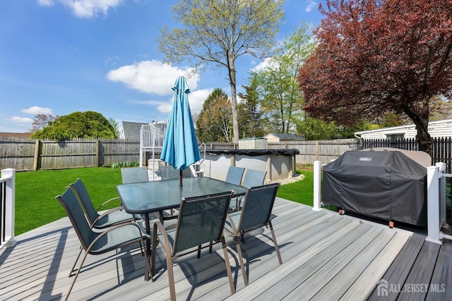 deck featuring outdoor dining space and grilling area