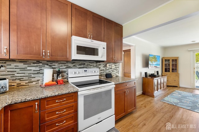 kitchen with white appliances, tasteful backsplash, light wood-type flooring, baseboards, and crown molding