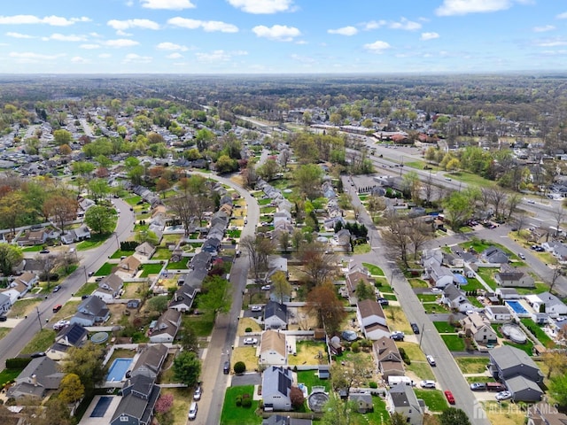 aerial view of property and surrounding area featuring nearby suburban area
