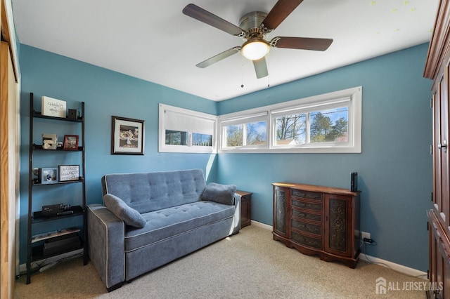 sitting room featuring carpet, a ceiling fan, and baseboards