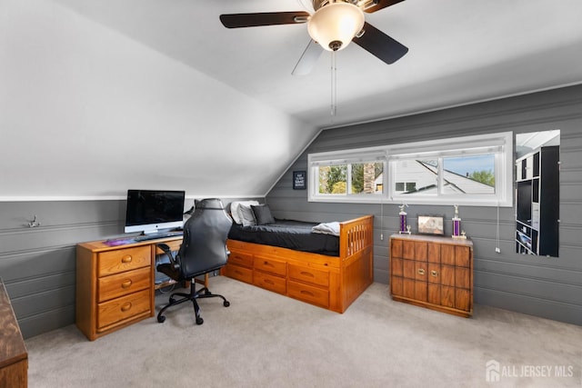 bedroom with light colored carpet, lofted ceiling, ceiling fan, and a desk