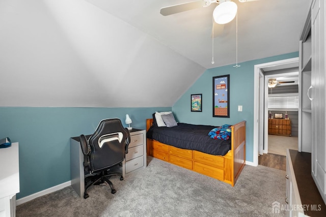bedroom featuring carpet flooring, lofted ceiling, ceiling fan, an office area, and baseboards