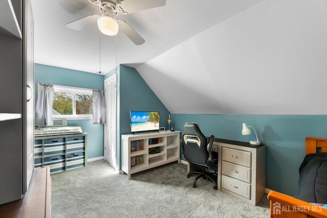 office area featuring vaulted ceiling, a ceiling fan, and carpet