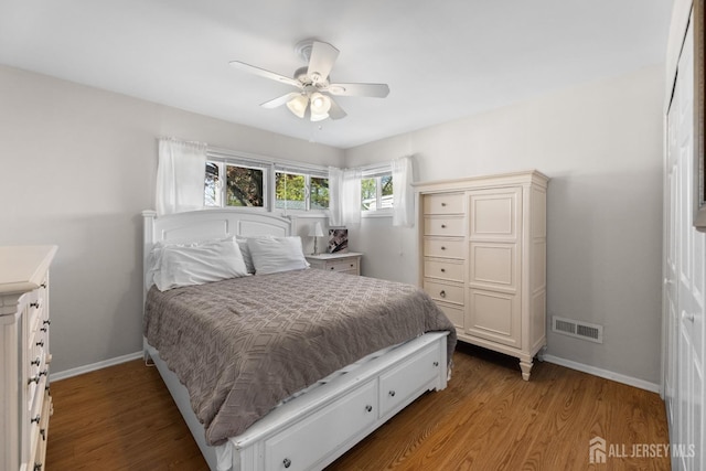bedroom with wood finished floors, baseboards, and ceiling fan