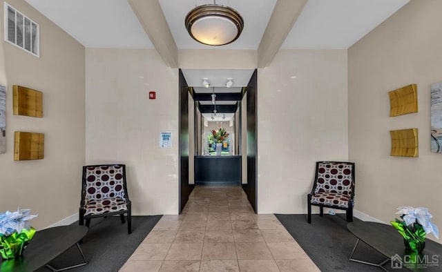 corridor featuring tile patterned flooring and visible vents