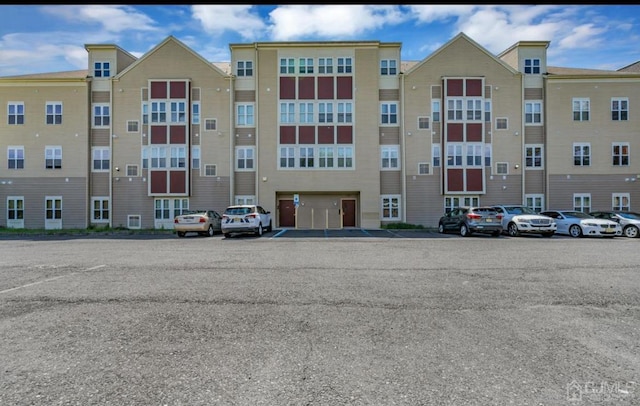 view of property with uncovered parking