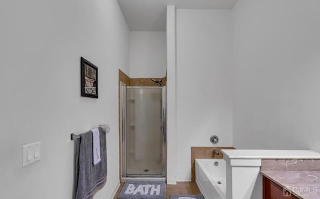 bathroom featuring vanity, tile patterned flooring, and separate shower and tub