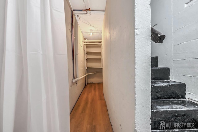 stairway with hardwood / wood-style flooring