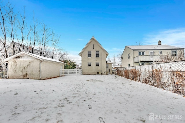 view of snow covered back of property