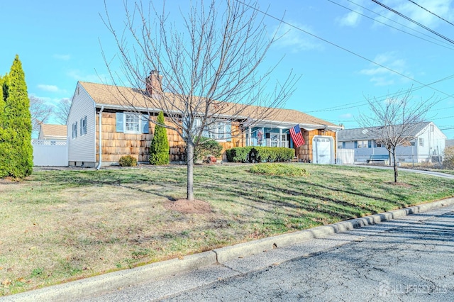 ranch-style house featuring a front yard and a garage