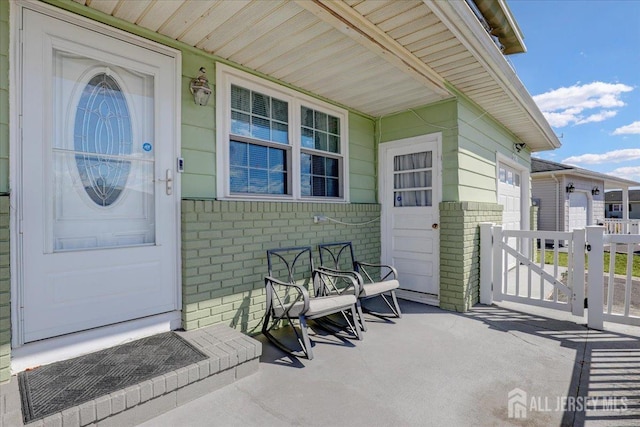 entrance to property featuring brick siding