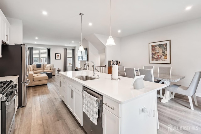 1915 Switzer Ave, Parlin, NJ 08859 - kitchen featuring a sink, stainless steel appliances, light wood-style flooring, an island with sink, and recessed lighting