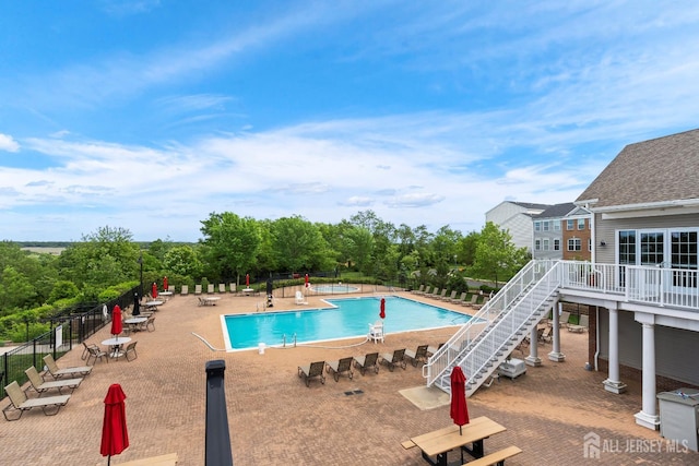 1915 Switzer Ave, Parlin, NJ 08859 - community pool featuring a patio area, view of scattered trees, and stairs