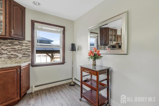 124 6th Ave, Middlesex, NJ 08846 - doorway featuring baseboard heating, light wood finished floors, and baseboards