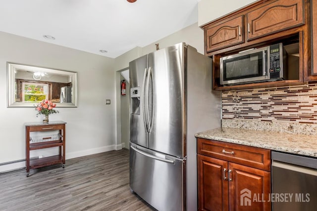 124 6th Ave, Middlesex, NJ 08846 - kitchen featuring appliances with stainless steel finishes, wood finished floors, backsplash, baseboards, and light stone counters