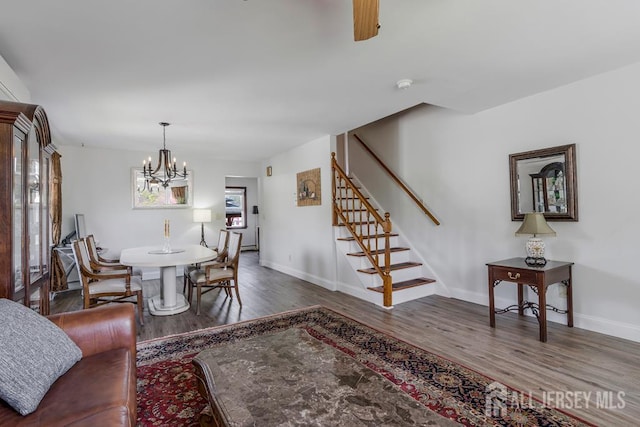 124 6th Ave, Middlesex, NJ 08846 - dining room featuring stairs, wood finished floors, a chandelier, and baseboards