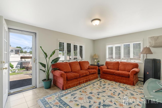 124 6th Ave, Middlesex, NJ 08846 - living area featuring light tile patterned floors and a baseboard heating unit