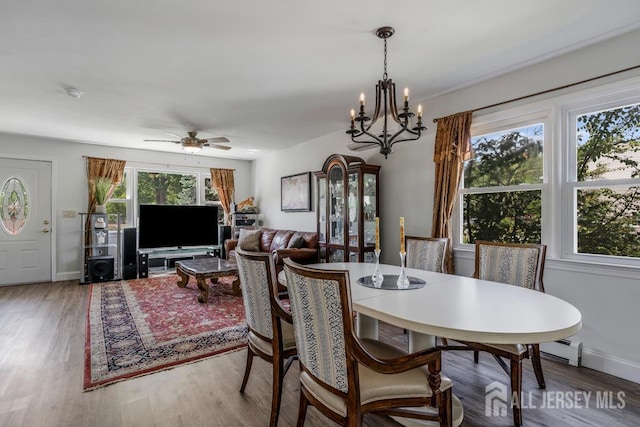 124 6th Ave, Middlesex, NJ 08846 - dining space with wood finished floors, a chandelier, a ceiling fan, and baseboards