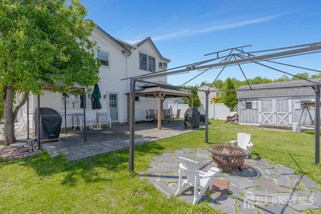 124 6th Ave, Middlesex, NJ 08846 - back of house with a gazebo, a fire pit, a storage unit, a patio, and an outbuilding